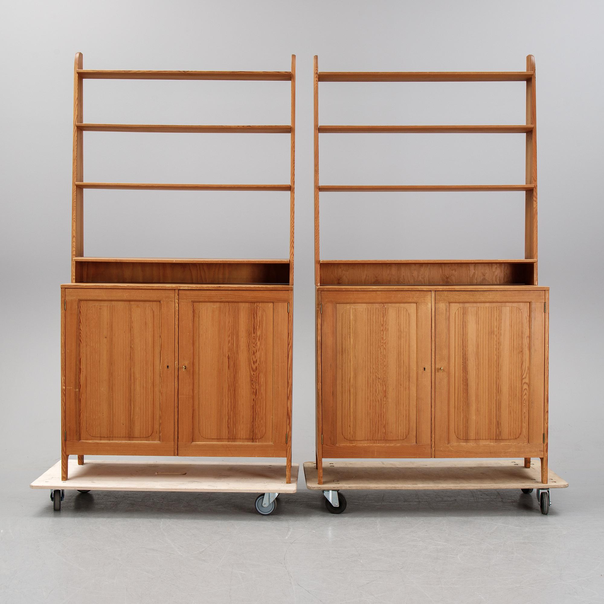 A pair of pine cupboards with shelves by Carl Malmsten.