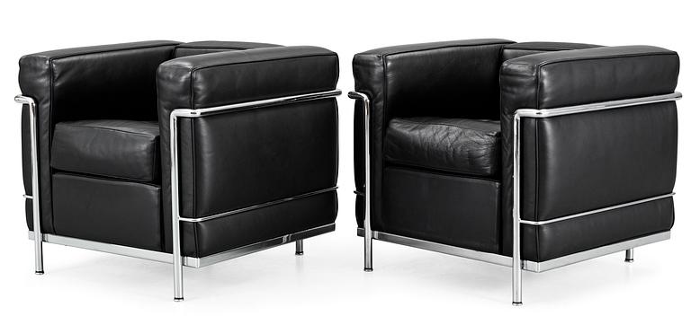 A pair of Le Corbusier 'LC 2' black leather and chromed steel easy chairs, by Cassina, Italy.
