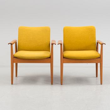 A pair of "Diplomat" easy chairs by Finn Juhl.