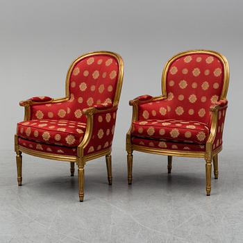 A pair of Louis XVI-style armchairs.