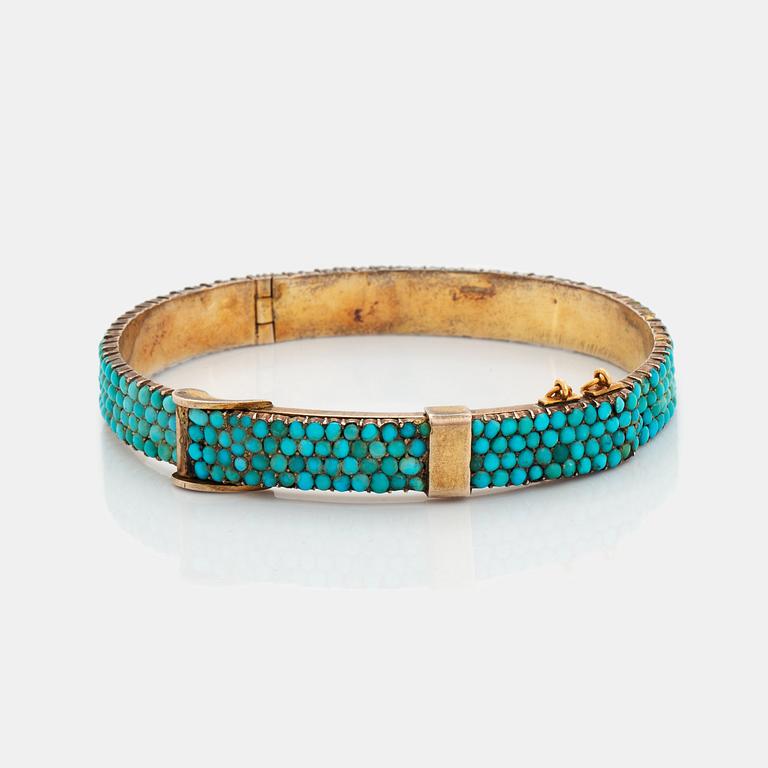 A silver and turquoise bracelet.