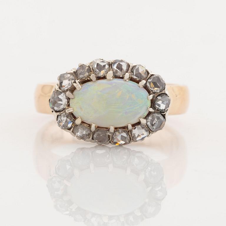 An 18K gold and opal ring set with rose-cut diamonds.