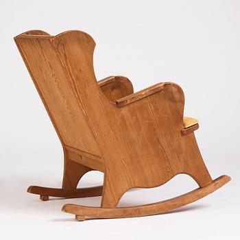 Nordiska Kompaniet, a Swedish Modern stained pine 'Lovö' rocking chair.