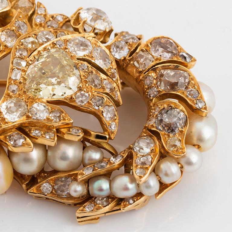 An 18K gold brooch/pendant set with old- and rose-cut diamonds and pearls.