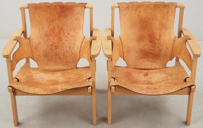 A pair of Carl-Axel Acking oak and beige leather armchairs, 'Trienna', Sweden 1950's-60's.