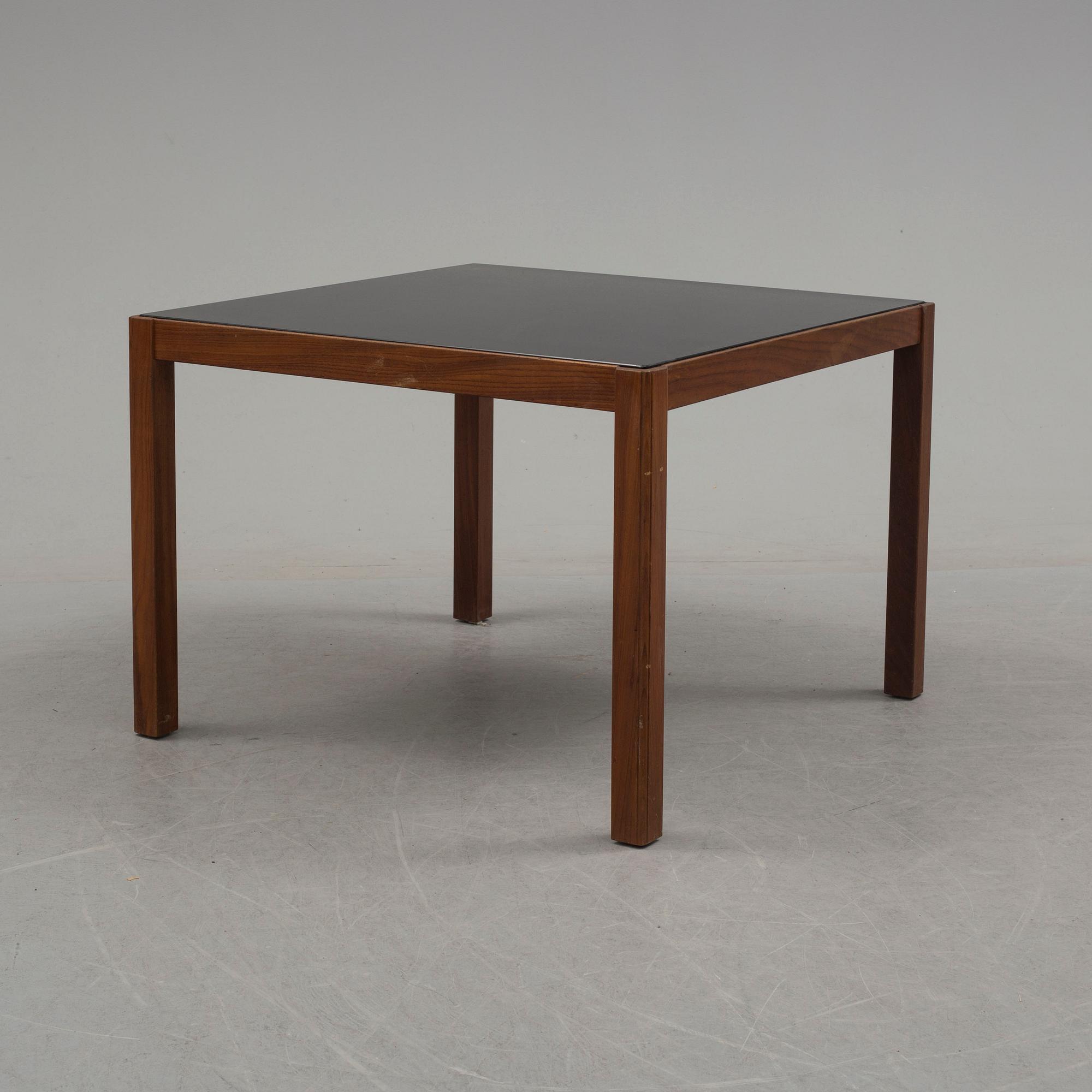 A 1960's teak coffee table with glass top.