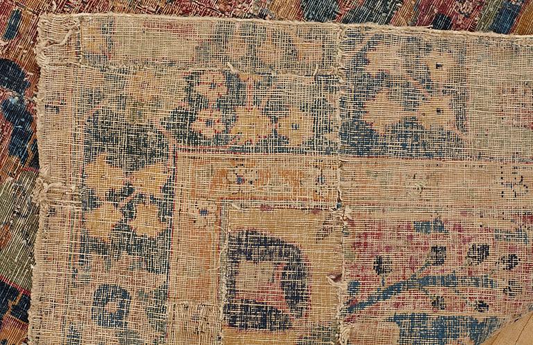 CARPET FRAGMENTS an antique Kerman Vase-carpet, the beginning of the 18th century, ca 193,5 x 103,5 cm.