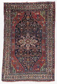 An oriental, semi-antique rug, c. 195 x 130 cm.