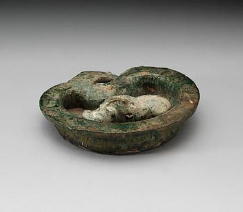 A green glazed heart shaped pigsty with pig, Han dynasty (206 BC- 220 AD).