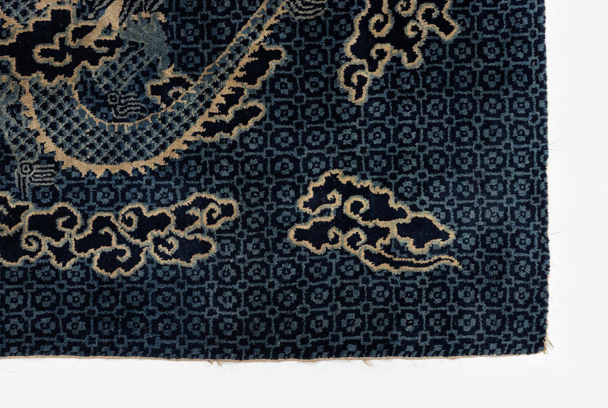 A Chinese 'dragon' rug, circa 1920. (c 190x122 cm).