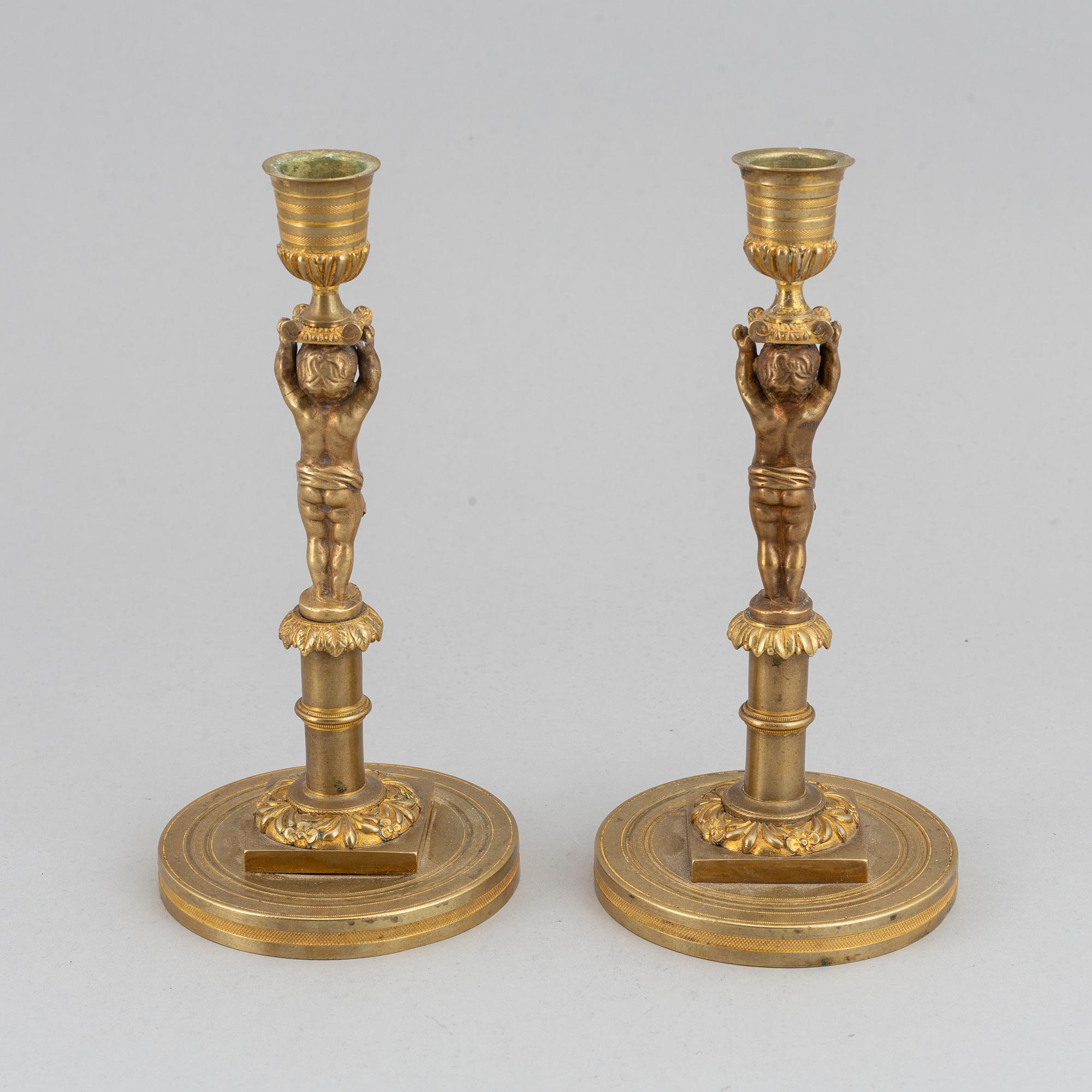 A pair of 19th Century bronze empire style candlesticks.