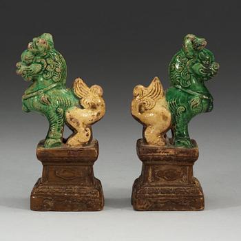 A pair of brown, green and yellow glazed joss stick holders, Qing dynasty (1644-1912).