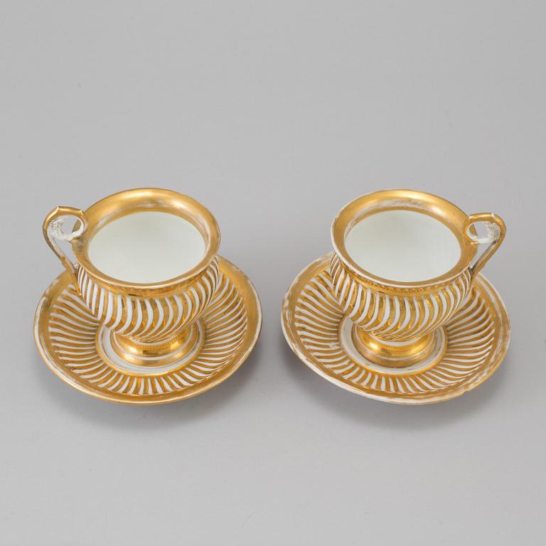 a pair of late empire porcelain cups with saucers from the first half of the 19th century.