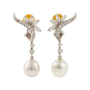 501A. A pair of platinum earrings with cultured pearls and navette- and round brilliant-cut diamonds.