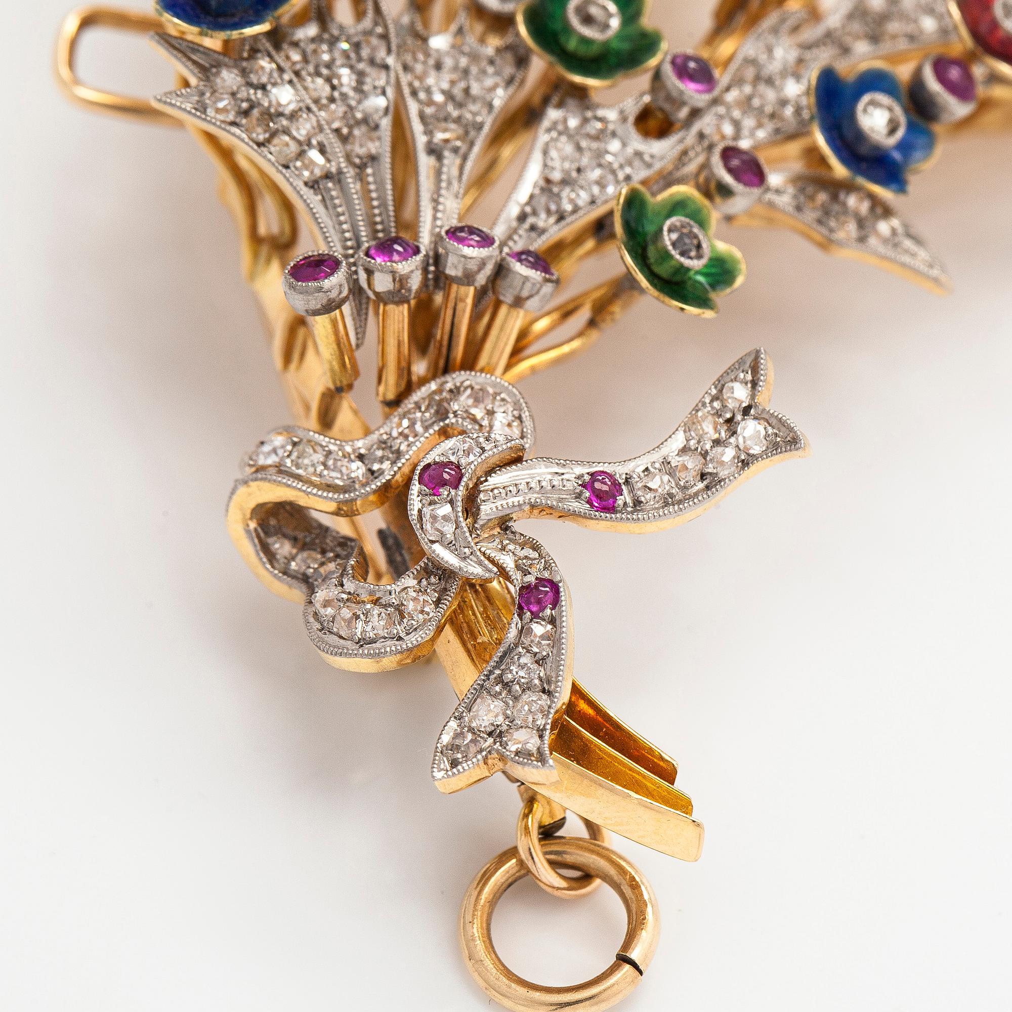 A 17K gold brooch/pendant with rose-cut diamonds, cabochon-cut rubies and enamel.
