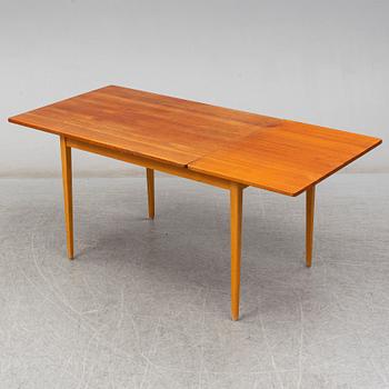 A 1960s teak veneered dining table.