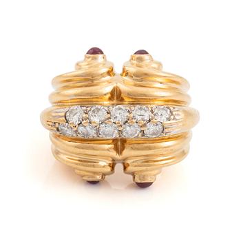 484. An 18K gold ring set with round brilliant-cut diamonds and cabochon-cut rubies.