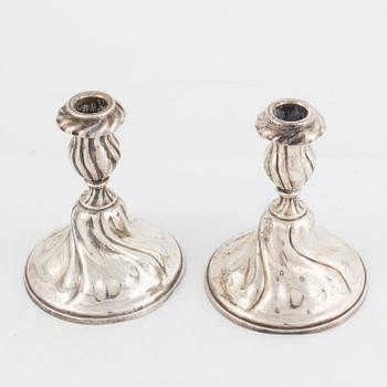 A pair of silver rococ-style candle sticks, presumably Germany, 20th century.