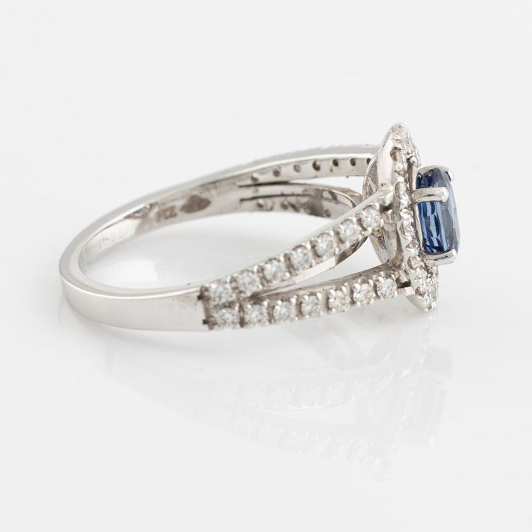 Ring 18K white gold set with an oval faceted sapphire and round brilliant-cut diamonds.