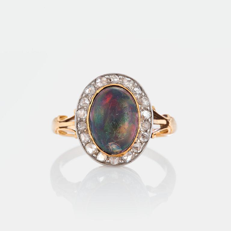 An opal ring set with rose-cut diamonds.