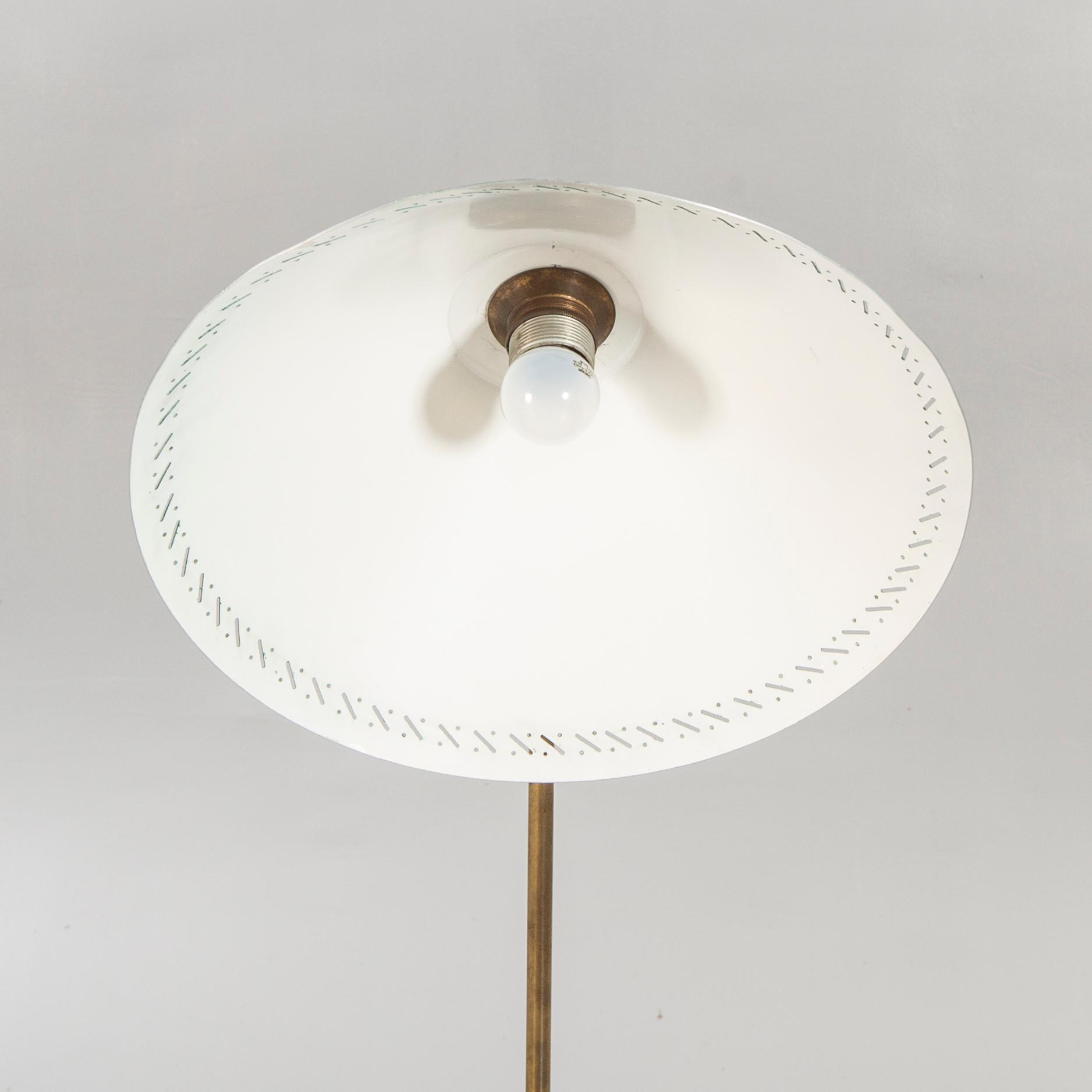 A 1950s brass floor lamp.