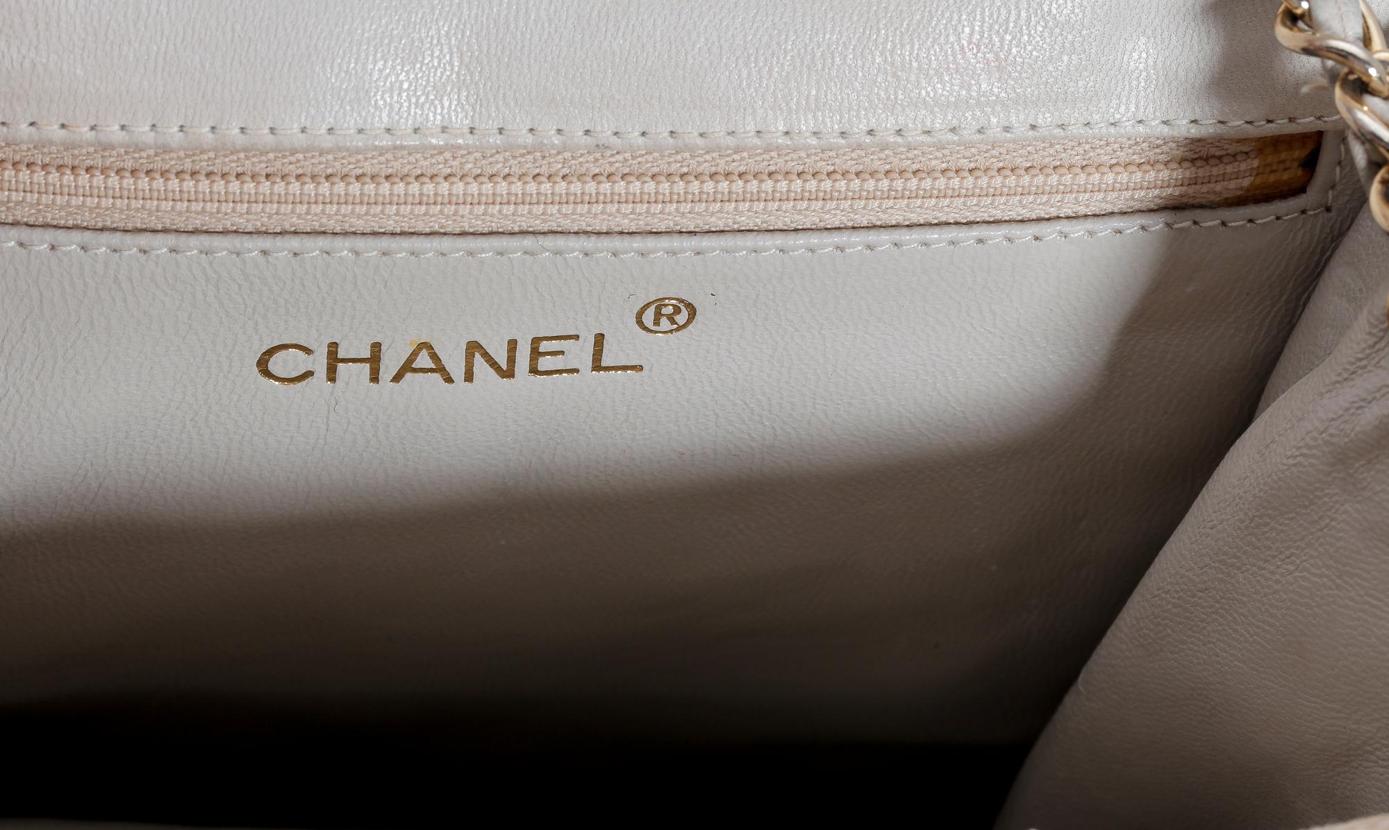 A beige shoulder bag by Chanel.