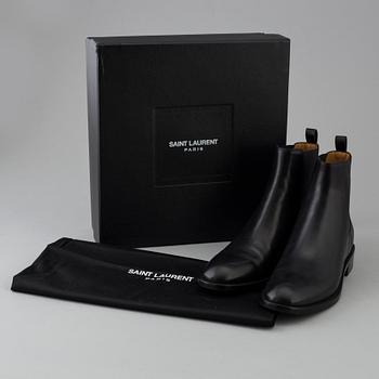 Black leather boots by Yves Saint Laurent.