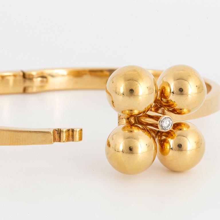 ARMRING, 18K guld med briljantslipad diamant, Design Relo Luzern.
