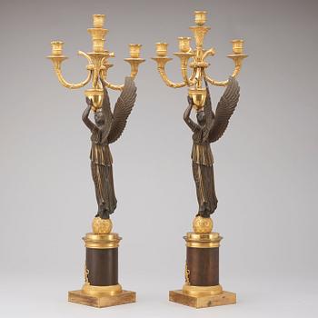A pair of Empire early 19th century five-light candelabra.