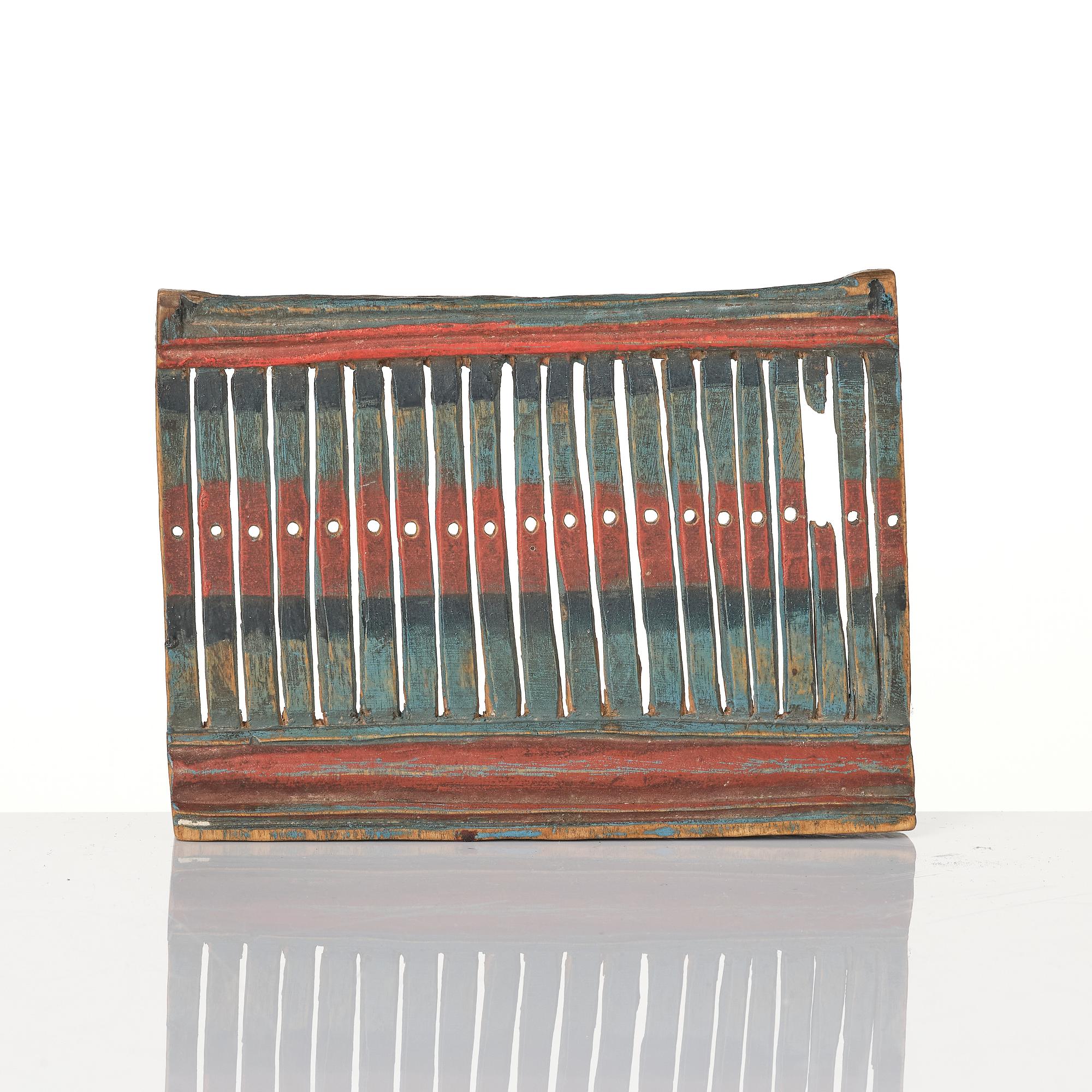 A Swedish carved and polychrome painted weaving tool from Hälsingland, 19th century.
