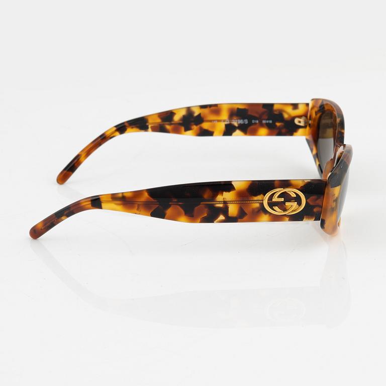 Gucci, a pair of gold tone logo sunglasses.