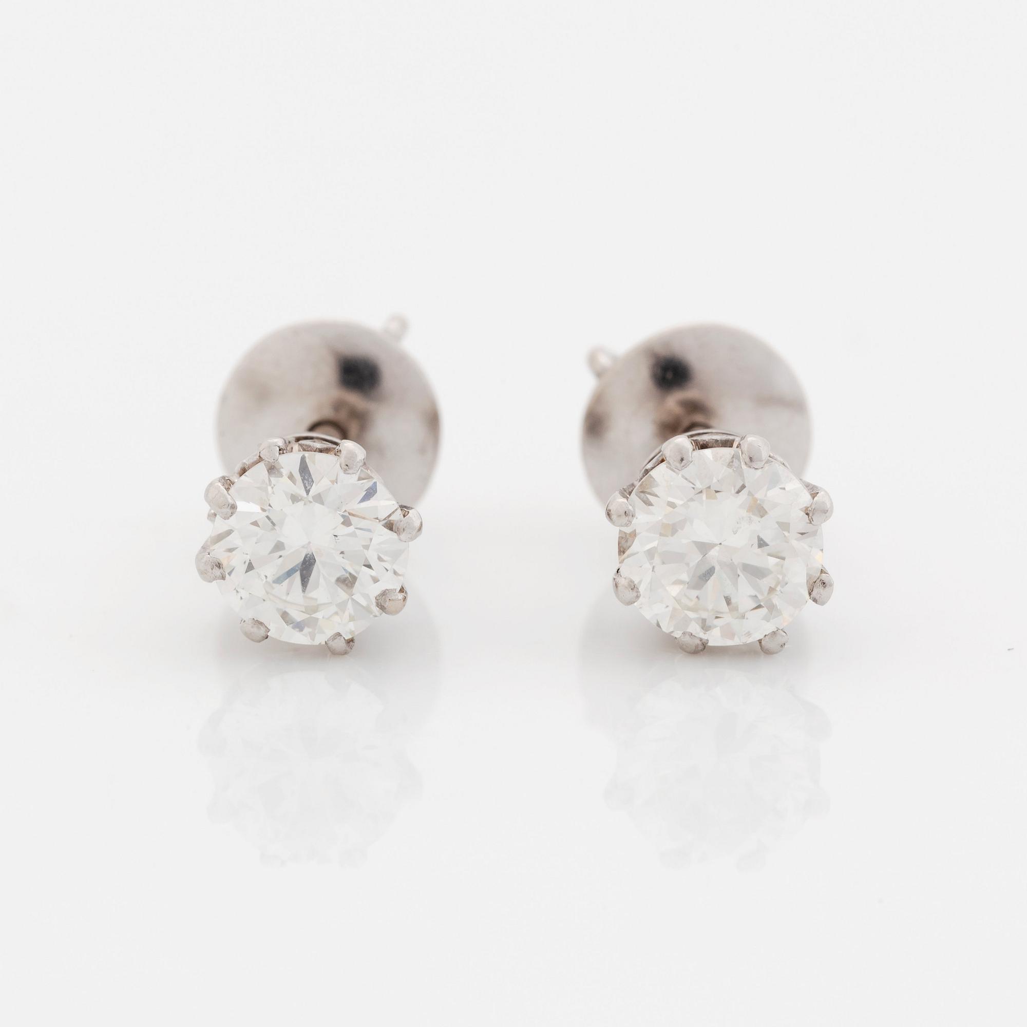 A pair of 18K white gold earrings set with round brilliant-cut diamonds.