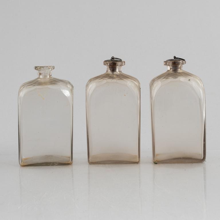 A wooden box with three glass flaska, first half of the 19th century.