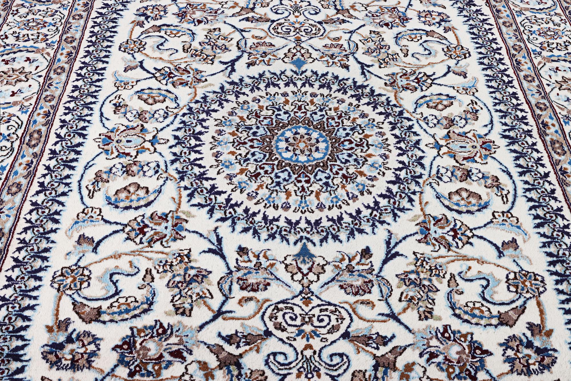 A Nain carpet, part silk, c. 291 x 201 cm.