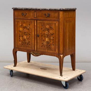 A French Louis XVI-style cupboard, ca 1900.