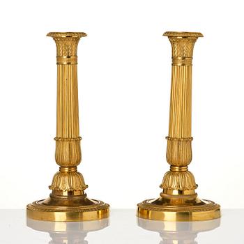 A pair of French Empire gilt-bronze candlesticks, early 19th century.