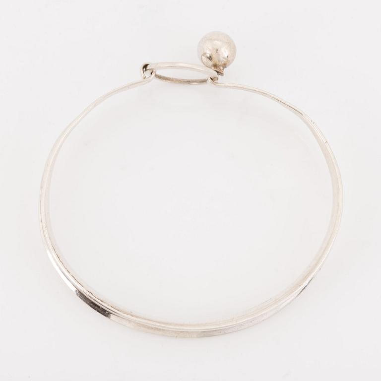 A silver Erik Granit bracelet.