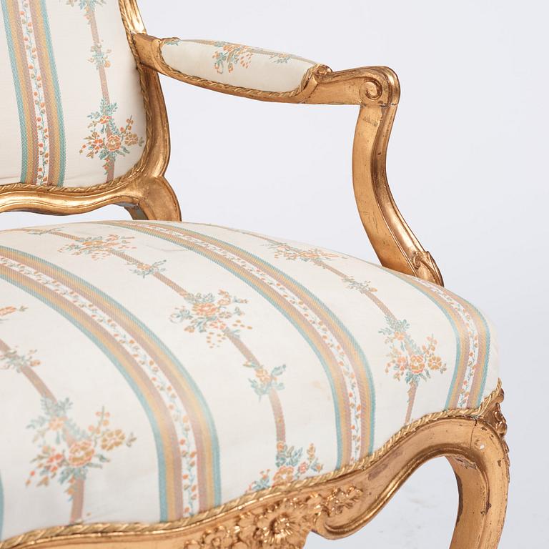 A Rococo armchair 18th century, (one later copy will follow the lot).