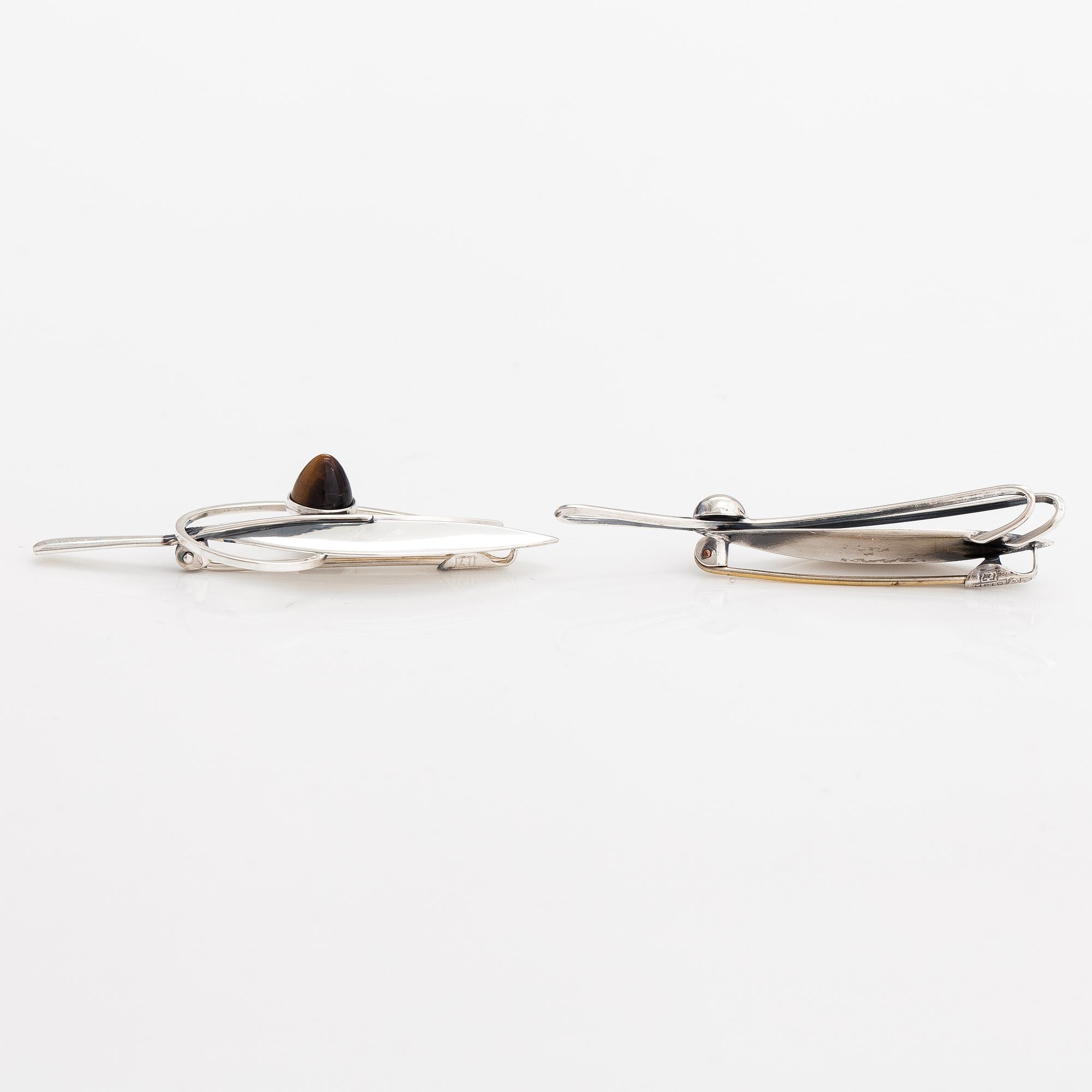 Elis Kauppi, Two silver brooches, one with a tiger's eye. Kupittaan kulta, Turku 1959 and 1962.