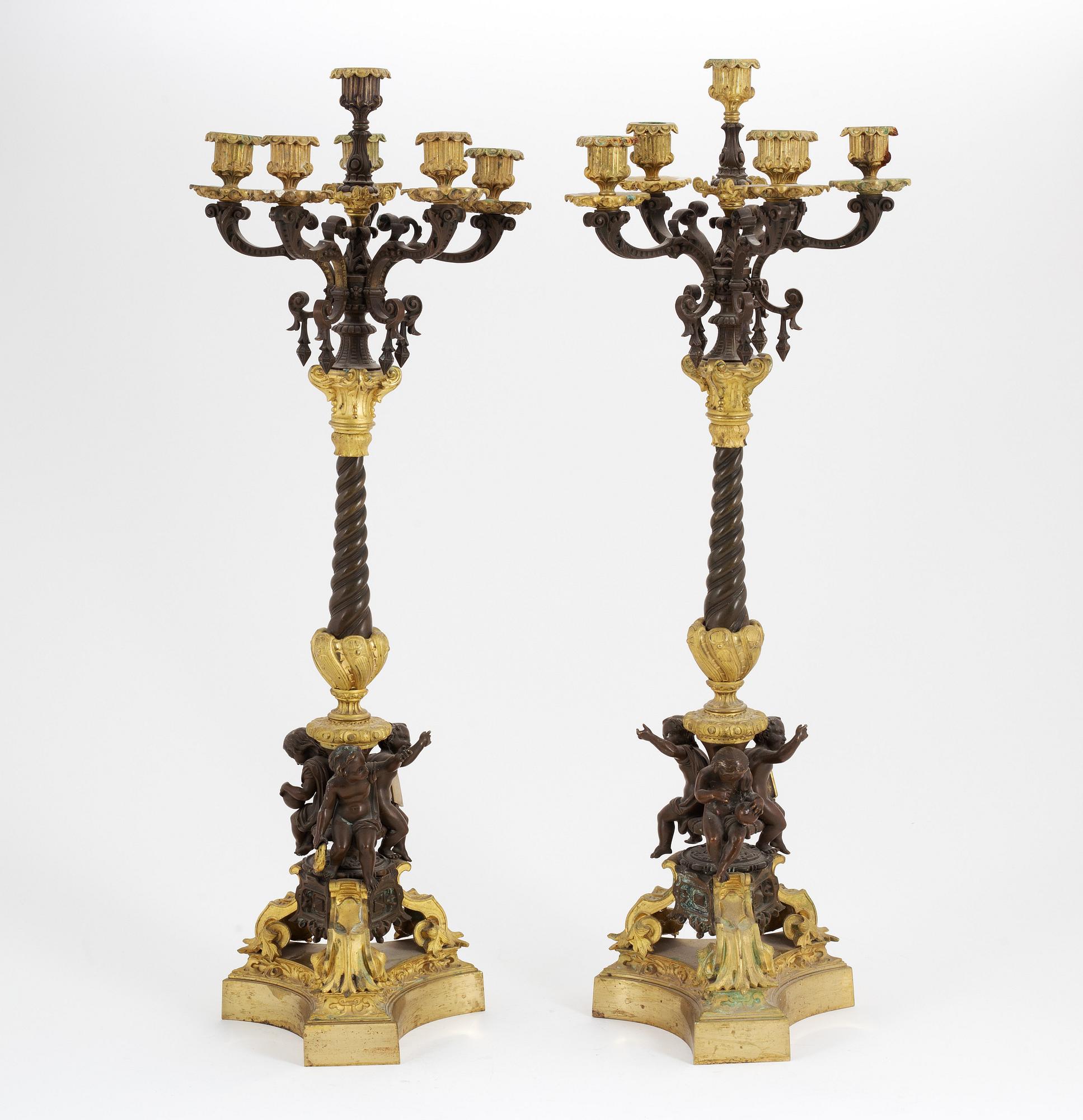 A pair of patinated bronze and ormolu neo-renaissance six-light candelabra, later part of the 19th Century.