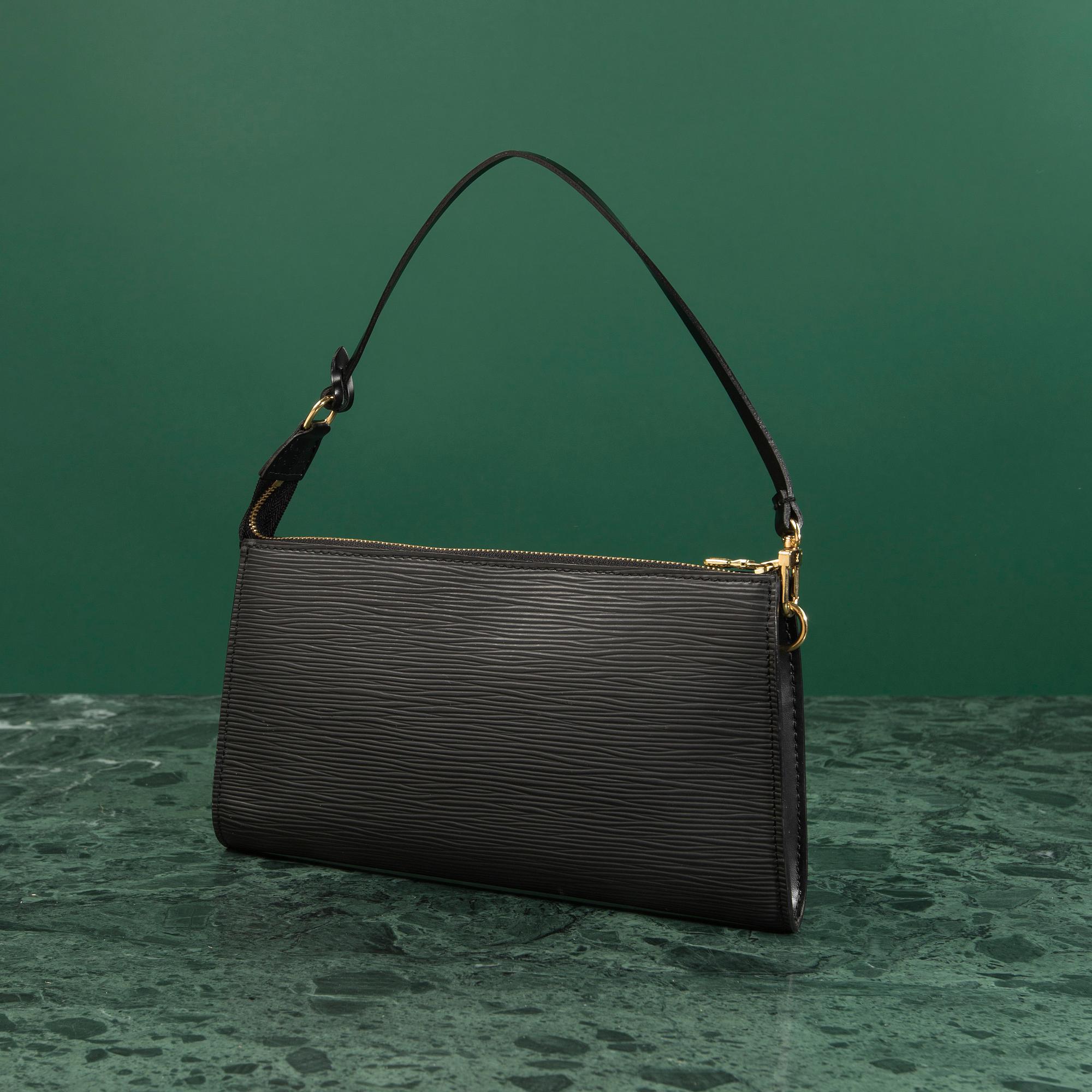 A bag  "Pochette Accessoires" by Louis Vuitton.