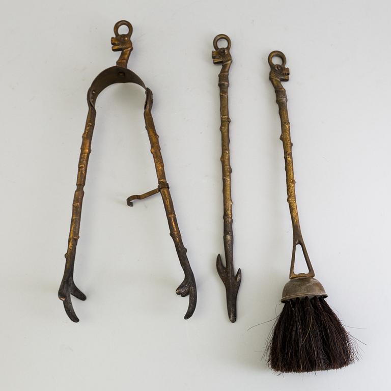 A set of three, early 20th century, bronze fire irons together with a stand, Nestor, England.