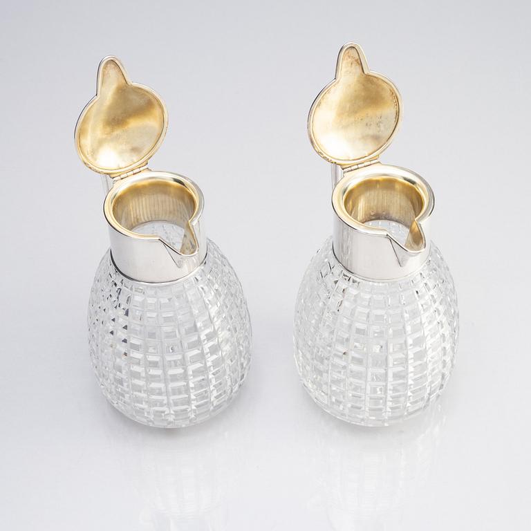 A pair of parcel-gilt silver and "hobnail" crystal decanters, W.A. Bolin, Stockholm 1920.