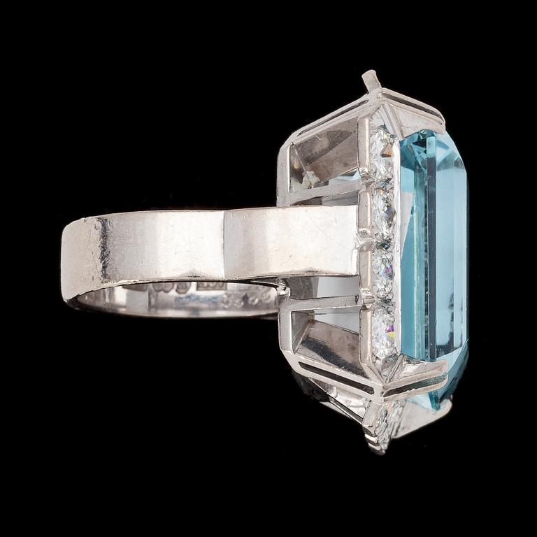 A stepcut aquamarine, 22.28 cts, and brilliant cut diamond ring, tot. 2.30 cts, 1975.