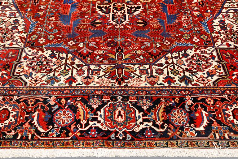 A  semi-antique Heris carpet, approx. 396 x 286 cm.