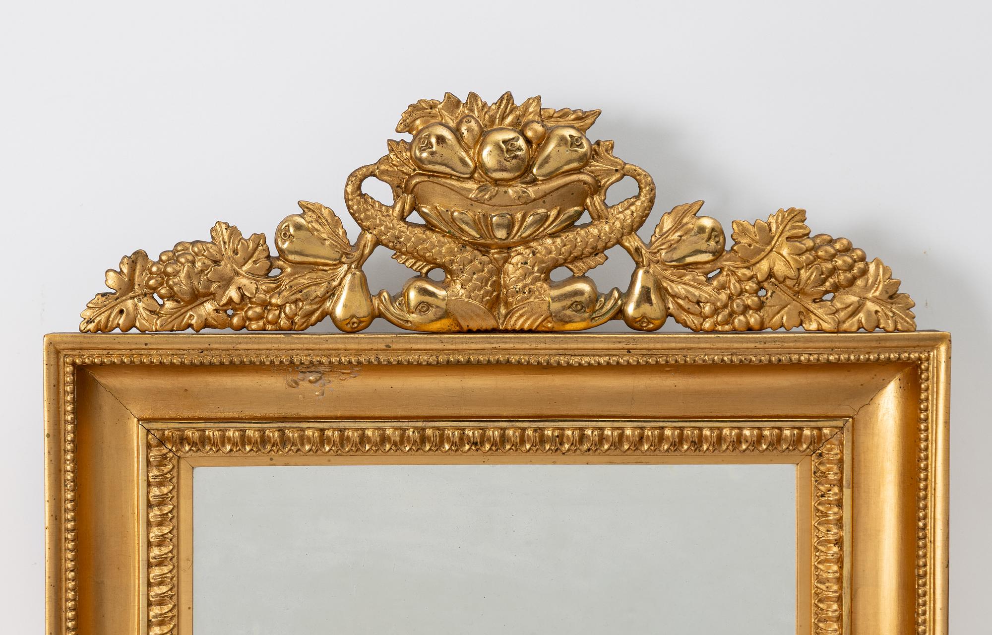 A pair of Late Empire gilded mirror sconces for two candles, Gothenburg, 1830s-40s.