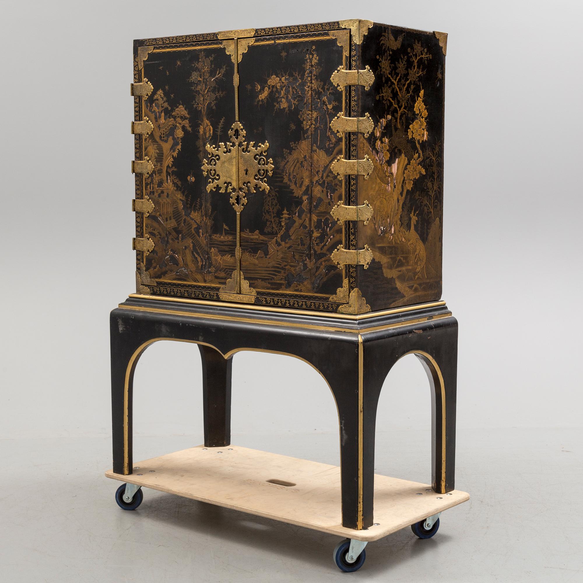AN early 18TH CENTURY PROBABLY ENGLISH Japanned laquer cabinet on stand.