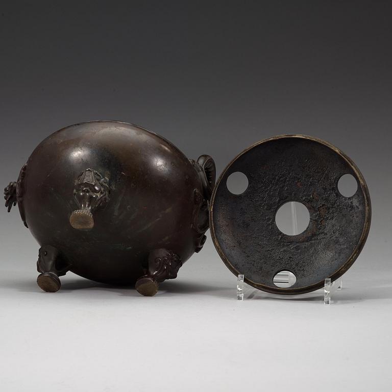 A bronze tripod censer with cover and stand, Qing dynasty, 17/18th Century.