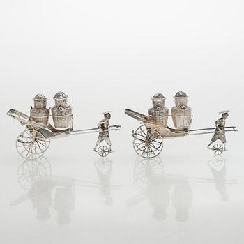 Four shakers in a pair of miniature rickshaws, sterling silver, maker's mark of Wai Kee, Hong Kong.