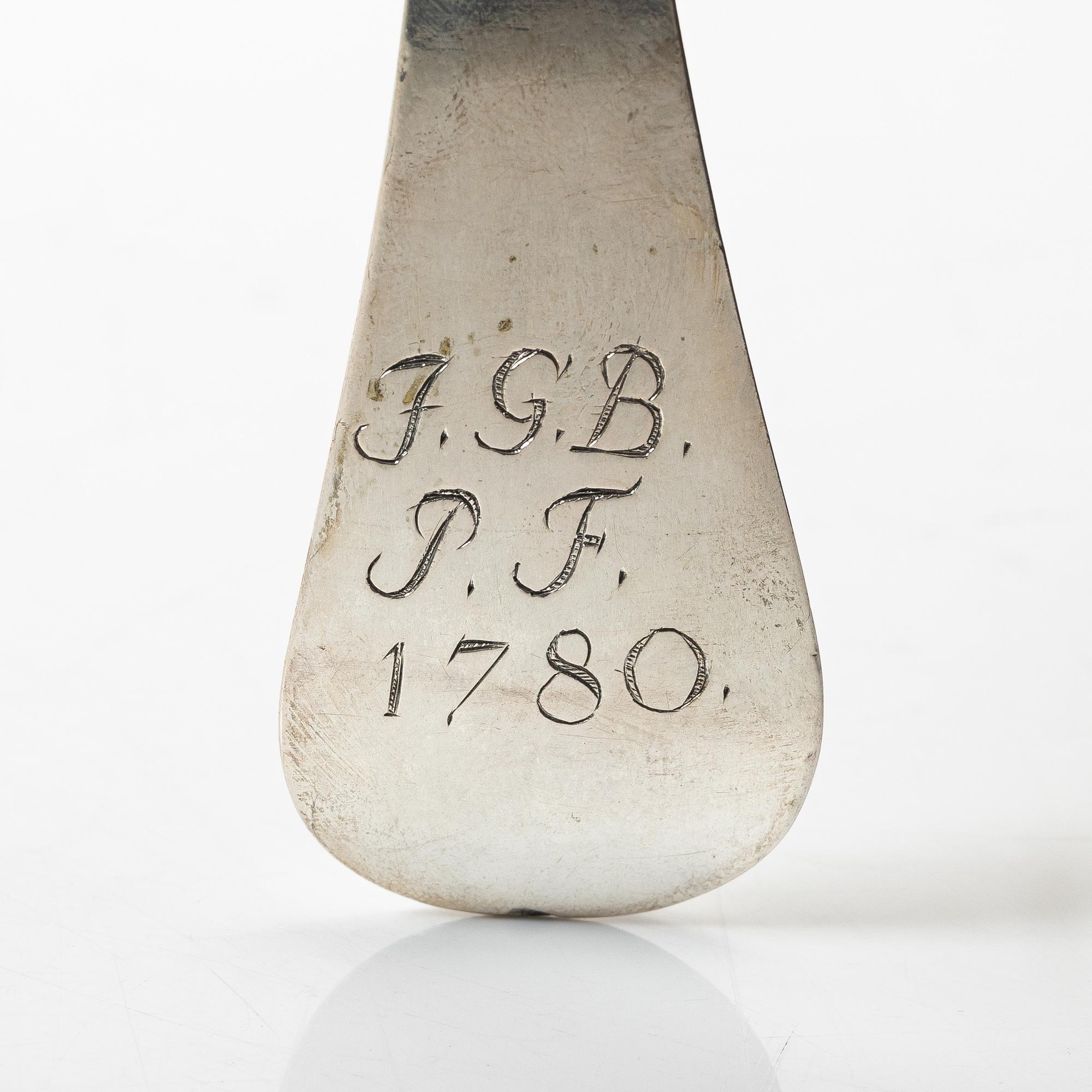 Two silver serving spoons with pseudo-marks, around the year 1900.